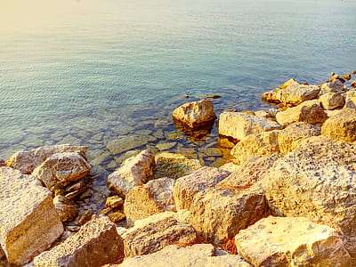 Photo of Boulders Near Body of Water thumbnail