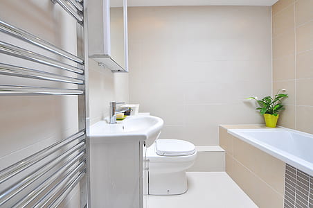 white ceramic sink and toilet bowl with white painted wall thumbnail