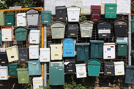 assorted mailboxes on fence thumbnail