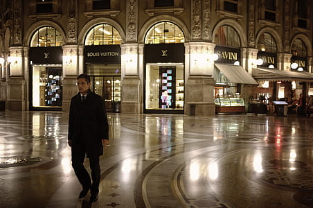 man walking in front of Louis Vuitton store thumbnail