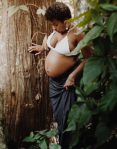 woman standing beside tree thumbnail
