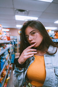 shallow focus photo of woman touching lips thumbnail