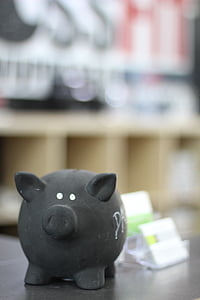 black piggy bank on black surface thumbnail