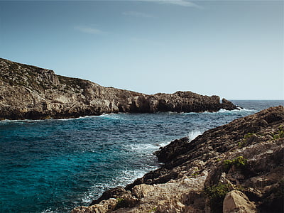 body of water near rocks thumbnail