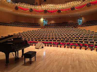 black grand piano on beige parquet stage thumbnail
