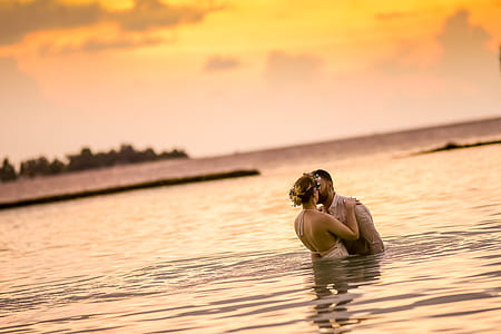 Woman and Man Kissing in Body of Water thumbnail
