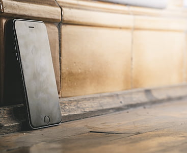 space gray iPhone 6 beside brown wall thumbnail