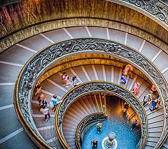 people walking on spiral stair case thumbnail