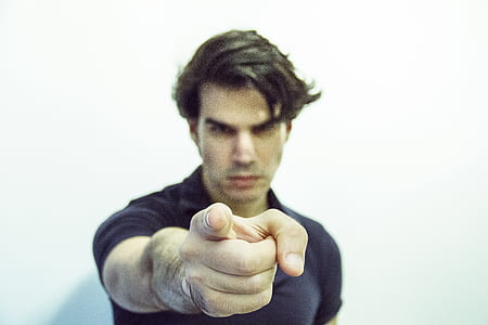 man pointing finger wearing black polo shirt thumbnail