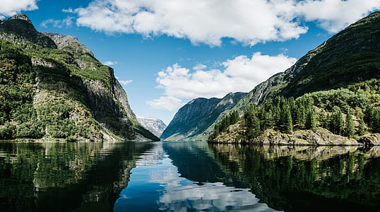 landscape photography of mountain and body of water thumbnail