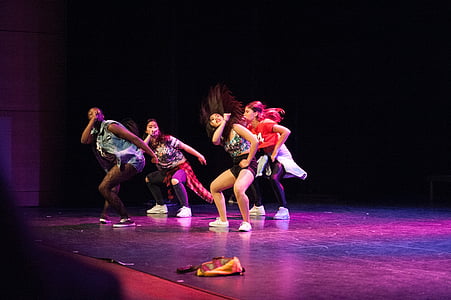 four women dancing on stage thumbnail