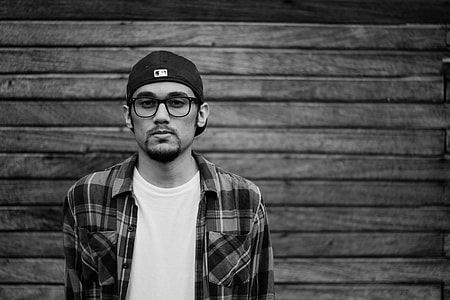grayscale photo of man behind wall thumbnail