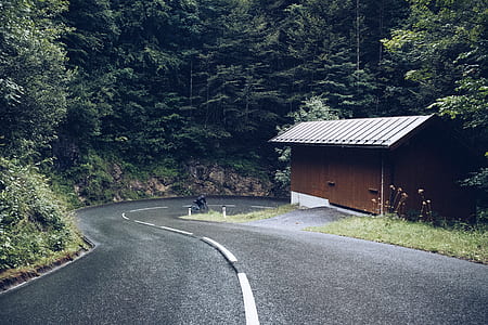 brown house beside asphalt road during daytime thumbnail