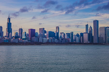 buildings near body of water under cloudy sky thumbnail