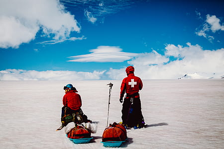 two person standing and sitting under white clouds and blue sky at daytime thumbnail