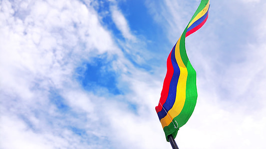 low-angle photography of red, blue, yellow, and green striped flag thumbnail