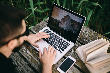 Man working on Macbook at lake thumbnail