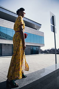 Woman in Yellow and Pink Floral Dress Standing thumbnail