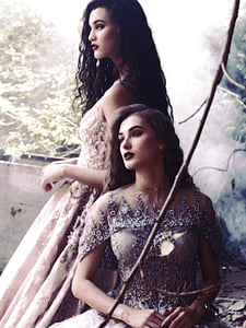 two woman wearing beige gowns doing pictorial thumbnail