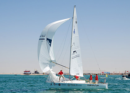 four people riding sailboat on body of water thumbnail