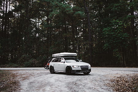 white Audi 5-door hatchback parked on dirt road near trees thumbnail
