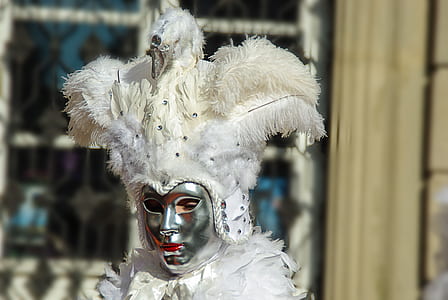 person wearing white and silver masquerade mask thumbnail