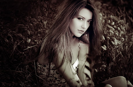 woman taking a photo surrounded with leaves thumbnail