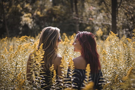 two women smiling while facing each other thumbnail