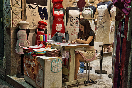 woman in black shirt sitting in front of sewing machine thumbnail