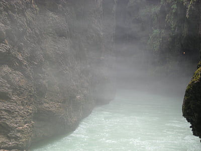 body of water surrounded by rock formation thumbnail