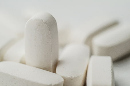 macro photography of white medication tablet thumbnail