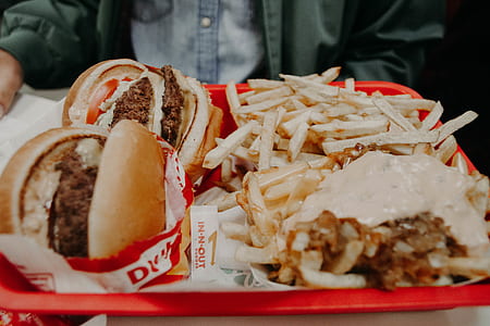 burgers and fries on red tray thumbnail