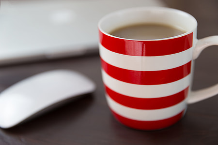 Coffee, computer and mouse on office desk thumbnail