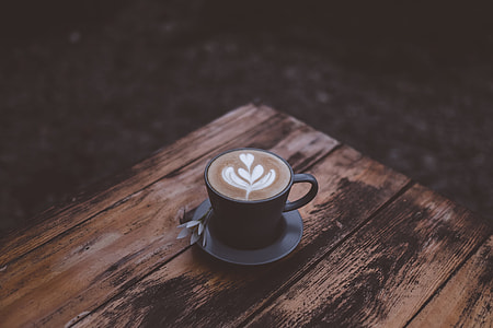 black ceramic mug on a brown wooden table thumbnail