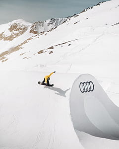 person riding on snowboard on snow covered slope thumbnail