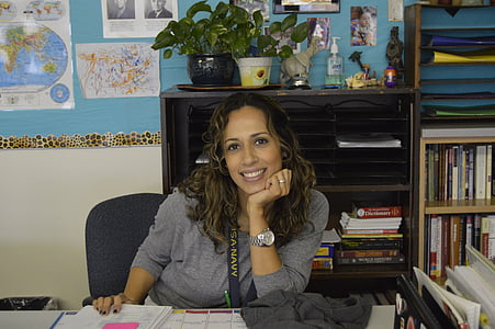 woman smiling leaning on desk thumbnail