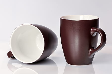 two black-and-white ceramic mugs on white surface thumbnail