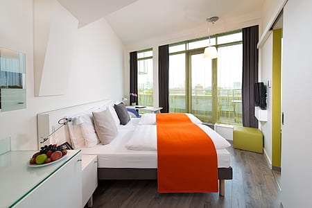black wooden bed frame and mattress beside wall thumbnail