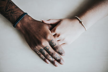 man and woman holding hands together thumbnail