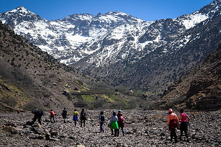 group of people far away from snow mountains thumbnail