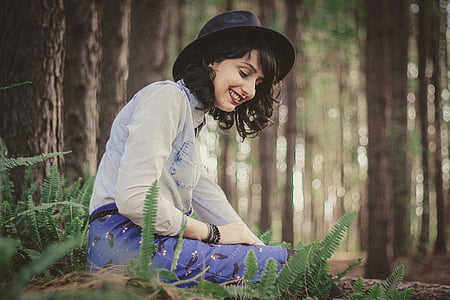 woman sitting beside brown tree thumbnail