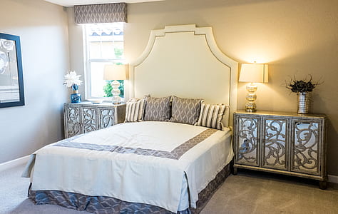 white wooden bed between brown wooden nightstands thumbnail