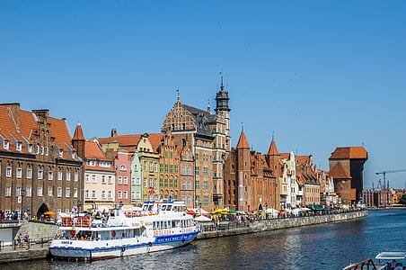 white boat docking near buildings thumbnail