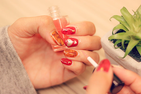 image contains person applying nail polish on left finger nai;l thumbnail