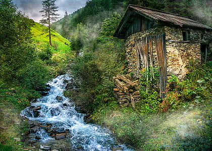 brown concrete shack near body of water thumbnail