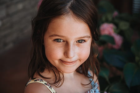 smiling girl in yellow and blue floral spaghetti strap top thumbnail