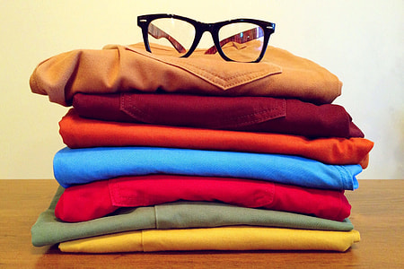 Clothing in pile with reading glasses thumbnail