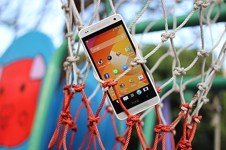 white HTC Android smartphone hanged on basketball net thumbnail