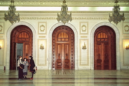 three woman standing at the hall near open door thumbnail