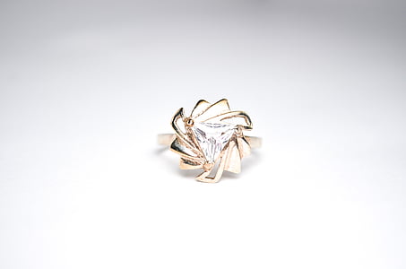 gold-colored clear gemstone encrusted ring on white surface thumbnail